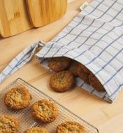 Cookies on a cooling rack and inside an open bread storage bag