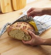 Placing a loaf of bread in the bread storage bag