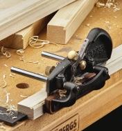 A right-hand box-maker’s plow plane being used to cut beading on the edge of a piece of wooden stock