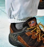 Close-up of the coverall pantleg cuff on a person’s ankle