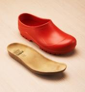 A red European garden clog shown with the molded cork insole removed