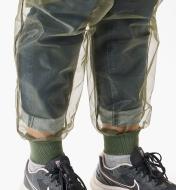 A close-up view of the rib-knit ankle cuffs on a pair of bug-protection pants worn by a woman