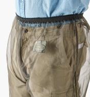 A close-up view of the elastic waistband on a pair of bug-protection pants worn by a woman