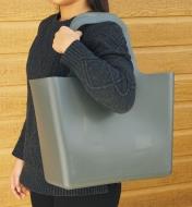 A woman carries the go-anywhere tote with the handles over her shoulder