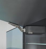 A soft-close system holds a cabinet door up