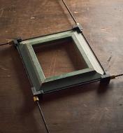 A Veritas 4-way speed clamp holding a square picture frame