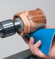 Sanding a wooden project on the lathe