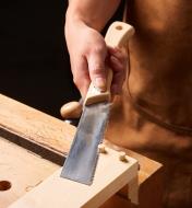 Cutting the ends off plugs in a board using a kugihiki saw