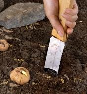Measuring soil depth for planting using a hori hori knife