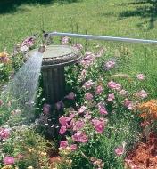 Spraying flowers in a garden with the Water Wand