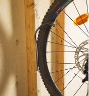 A bicycle tire attached to a rack on a wall