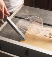 Push Stick being used to move stock along a table saw