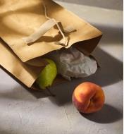 An open tree leather lunch bag lying on its side to dispense the contents