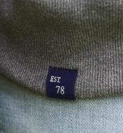 Close-up of Est 78 tag sewn onto bottom of sweatshirt