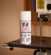 A can of Boeshield T-9 Protectant and Lubricant sitting on a saw table