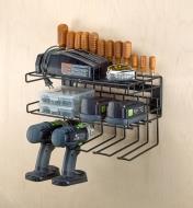 A wall-mount tool storage rack holds two cordless drills, batteries, chargers and accessories