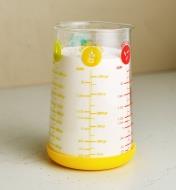 A measuring glass filled with flour