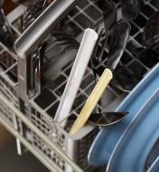 Two slider straw halves in a dishwasher with utensils