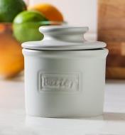 A white butter bell crock on a kitchen counter