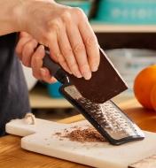 Using the ribbon paddle grater to grate chocolate