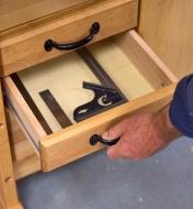 An open drawer with a combination square inside