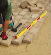 Using a 48" Stabila level to lay out patio stones