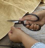Traditional Chinese scissors being used to cut fabric
