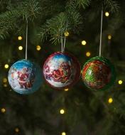 Trois boules de Noël 3D suspendues dans un sapin