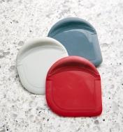 Three different-colored pan scrapers
