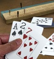 Three cards being held to show their faces
