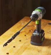 A GoDrilla and drill bit connected to a power drill