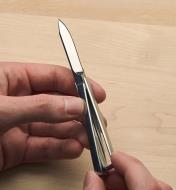 Holding the unfolded knife