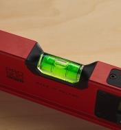 A close-up view of a digital spirit level, showing one of the bubble vials indicating a level surface