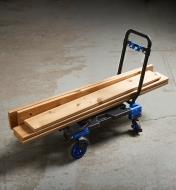 Several pieces of lumber loaded onto a dual hand truck and moving cart configured as a cart