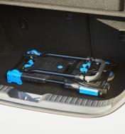 A dual hand truck and moving cart folded flat and placed in the trunk of a car