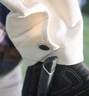 Close-up of the metal snap closure on a canvas arm protector