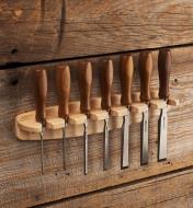 A seven-piece set of Veritas PM-V11 bench chisels held in a wall-mounted Veritas bench chisel rack