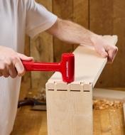 Using a hammer to assemble a dovetail joint