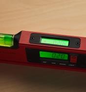 A close-up view of a digital spirit level, showing both LCD readouts indicating a 0.20-degree slope