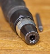 A close-up end-on view of the 1/4"" hex-shank bit holder in a 10-in-1 ratcheting screwdriver