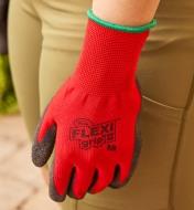 A close-up view of a Flex Grip glove, showing the snug, seamless fit around a woman's wrist