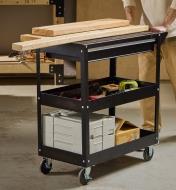Lumber, tools, toolboxes and other supplies loaded onto a workshop tool cart