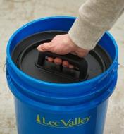 Pressing a bucket lid insert into a 5 gallon bucket