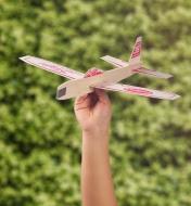 Child’s hand holds an assembled Balsa Glider