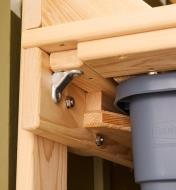 A close-up view of the underside of the cypress potting table and the reservoir