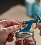 Turning the brass nozzle on the Air-Powered Spray Gun to adjust the diameter of the spray area