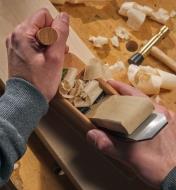 Using an E.C. Emmerich traditional wooden smooth plane on a cherry-wood board, seen from above