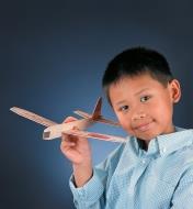 A boy plays with an assembled Balsa Glider