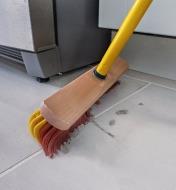 A Fusselschreck Indoor Broom is used to sweep a floor