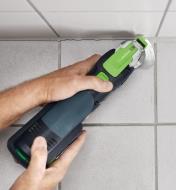 Removing caulking from bathroom tiles using an oscillating tool with a silicone blade attached